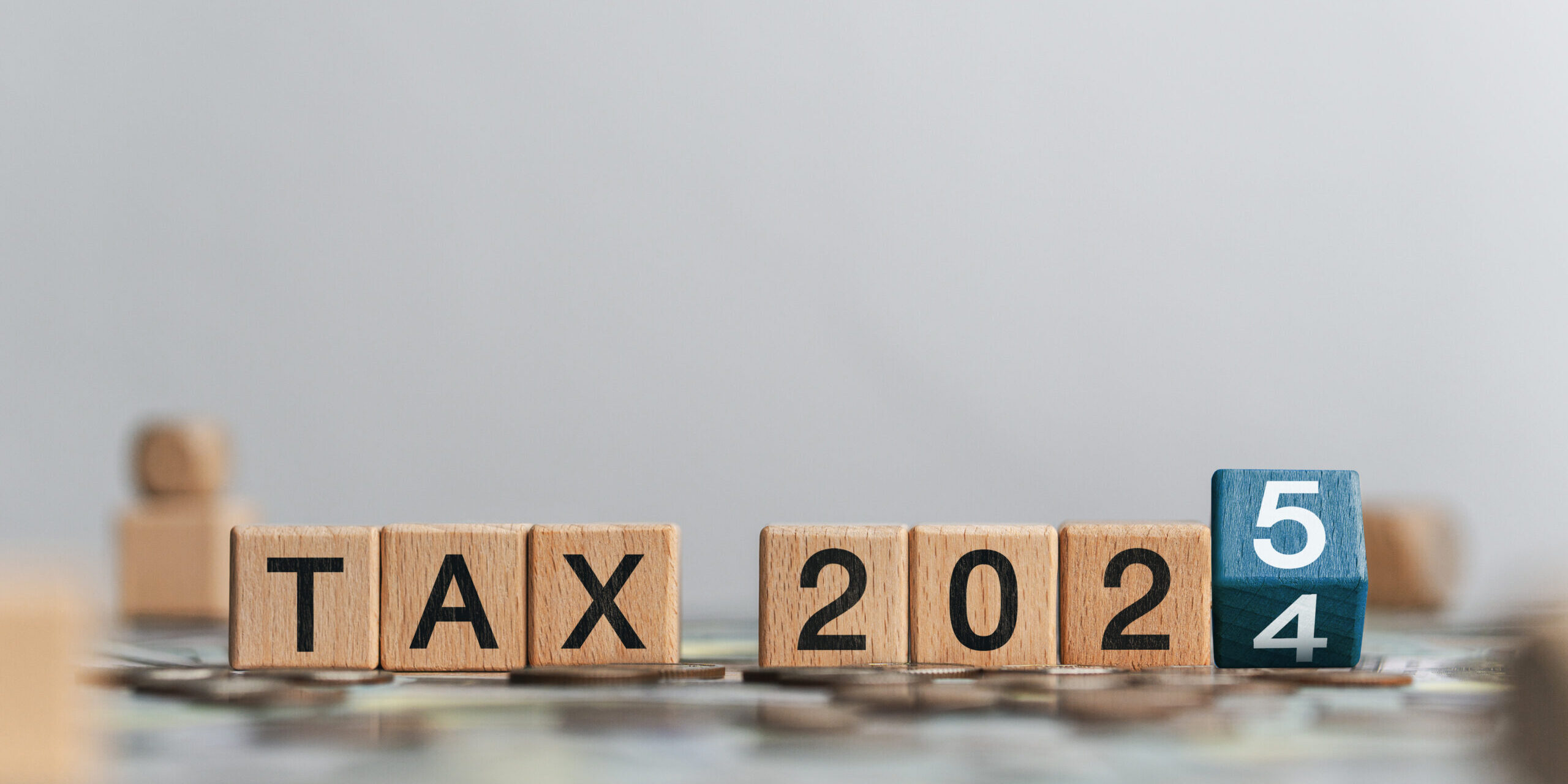 Business tax 2025 concept with wooden blocks and letters. Business budget planning and investment growth in new year concept. Income tax filing and tax filing to pay tax documents online.